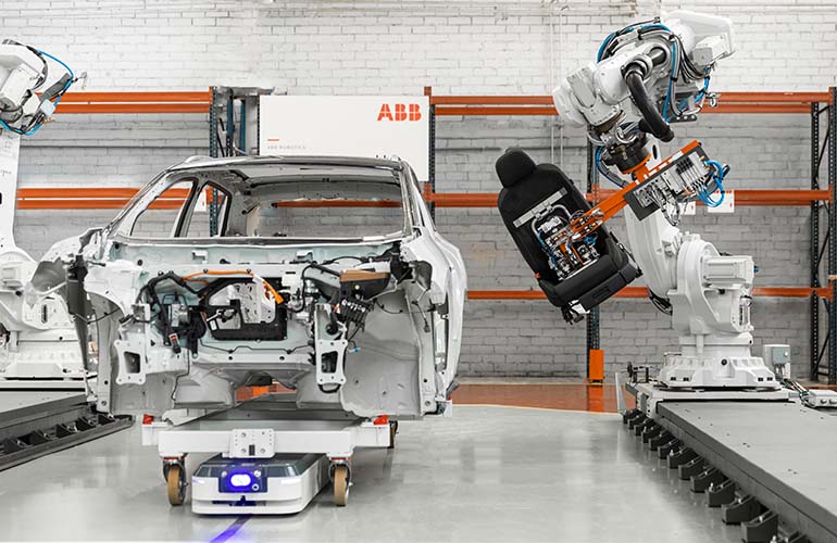 An ABB robot assembles a seat into an automotive
