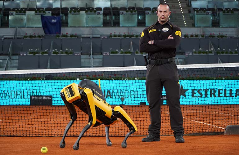 prosegur yellow robot on a tennis court next to a human security guard