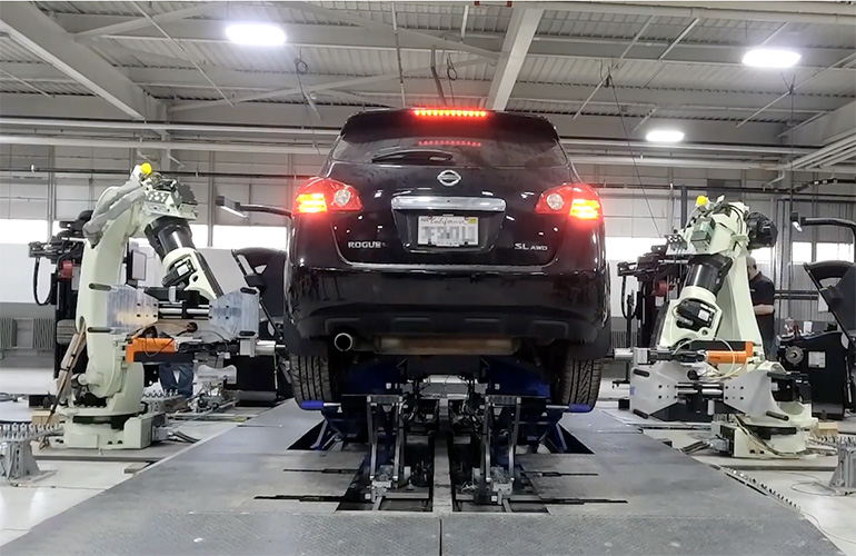 robotire robots work on a vehicle in an auto bay