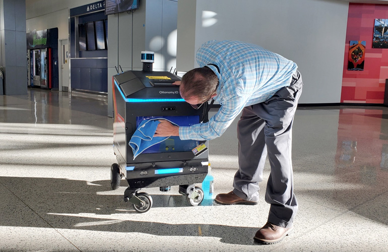 field service agent works on a mobile robot.