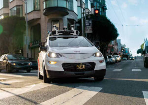 A Cruise robotaxi making a right turn on a San Francisco street.