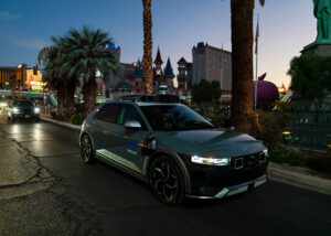 A Motional IONIQ 5 robotaxi driving in Las Vegas at night.