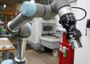 A Universal Robots collaborative robot arm with a robotiq gripper.