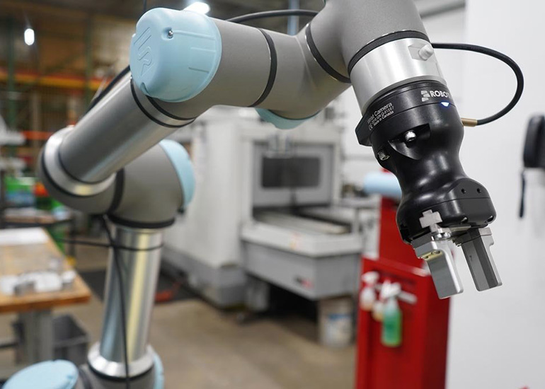 A Universal Robots collaborative robot arm with a robotiq gripper. 