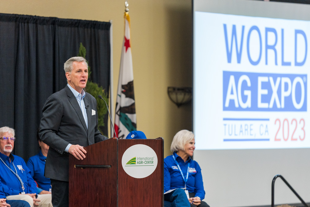 speaker of the house Kevin McCarthy at the podium in front of presentation screen.