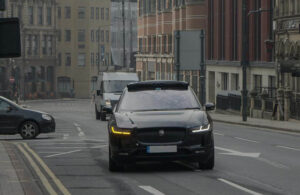 A black Wayve vehicle on the road in London.
