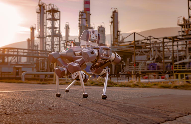 anybotics anymal quadruped robot patrolling an industrial facility.