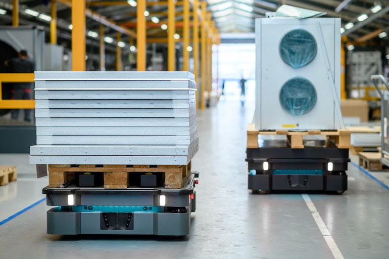 two MiR autonomous mobile robots operating inside a warehouse