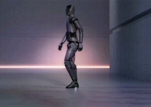 figure humanoid robot walks across stage in an illustration.