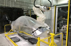 robot paints an aircraft canopy.