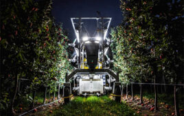 night time shot of the advanced farm apple picking robot in an orchard.
