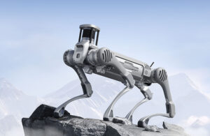 Unitree B2 quadruped robot standing atop a mountain.