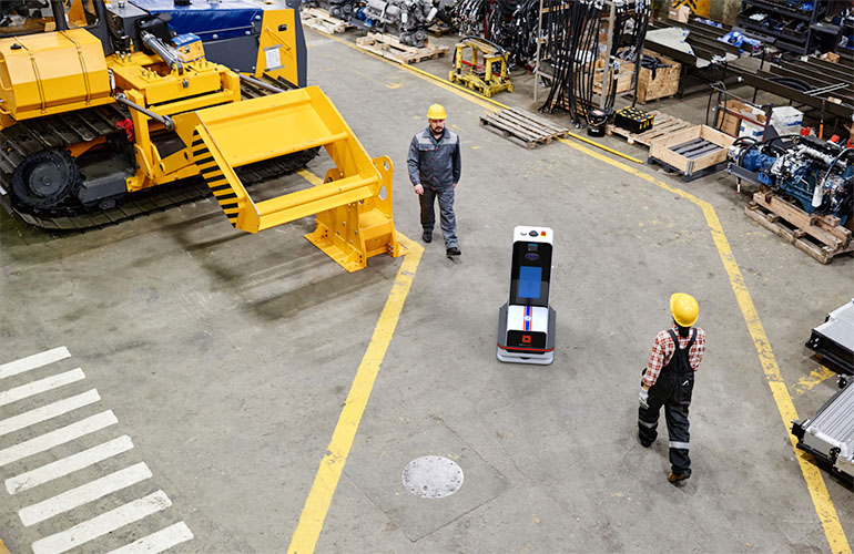 a flexqube navigator moves through a manufacturing warehouse.