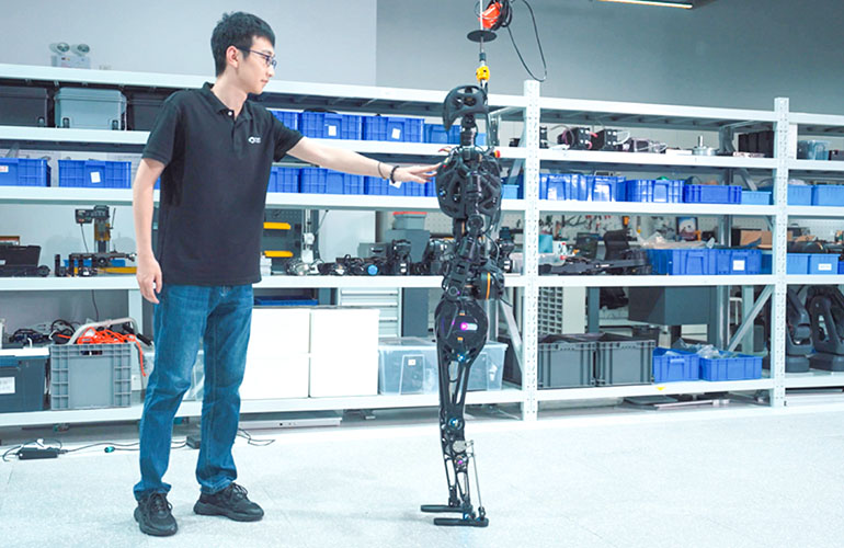 Fourier Intelligence GR-1 humanoid robot interacting with a human in the lab.