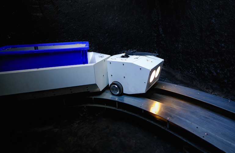 One of Pipedream's delivery robots traveling through its underground tunnel to deliver goods.
