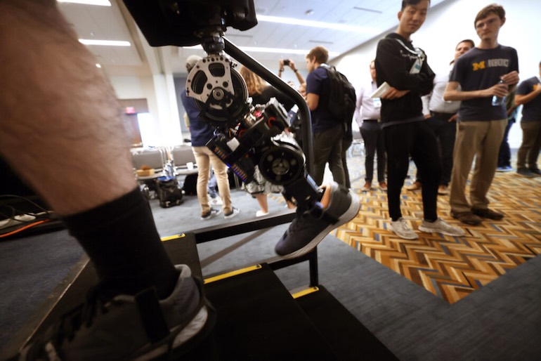 University of Michigan students demo a robotic prosthetic leg.