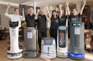 Parkhotel employees in Eisenstadt, Austria, celebrate the arrival of Pudu service robots.