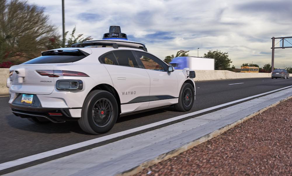 A Waymo robotaxi driving on a highway in Phoenix.