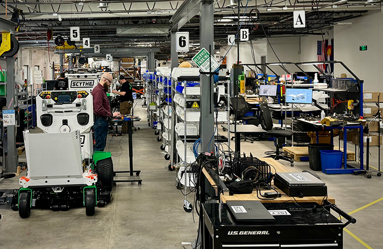 scythe production line with partially built mowers.