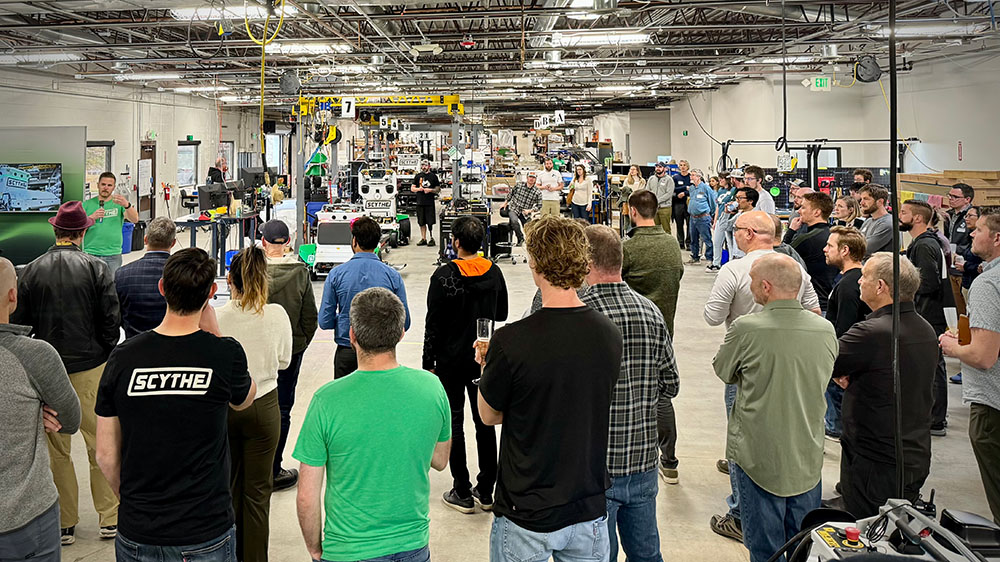 Employees gathered around CEO Jack Morrison on the production line.