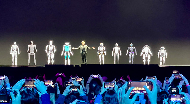 NVIDIA CEO Jenson Huang on stage with a humanoid lineup.