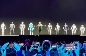 jenson on stage with humanoid robots.