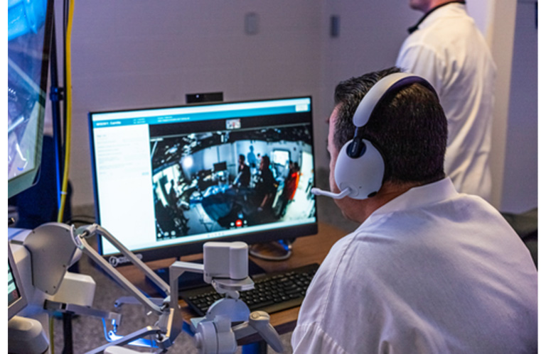 A surgeon speaks with the remote surgical care team 500 miles away through the Sovato Platform.