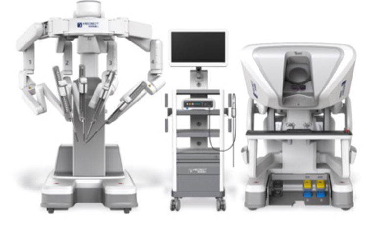 The Toumai endoscopic surgical system from MicroPort. The system is made up of three consoles, one with four surgical arms, one with a screen, and an image machine.