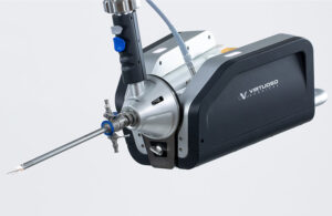 The Virtuoso robotic surgery system, which looks like a long needle coming from a black box. Researchers are adapting it to address prostate cancer surgery.