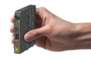 A white hand holding the new COVAL MPXS micro vacuum pump.