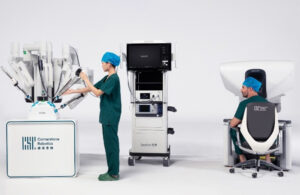 An image of Cornerstone Robotics' Sentire system, which features three robotic arms and a surgical console.