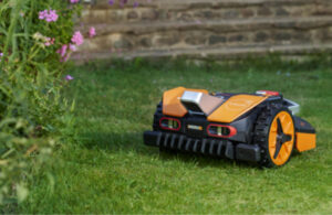 An image of an orange and black robotic lawn mower from Positec Group.