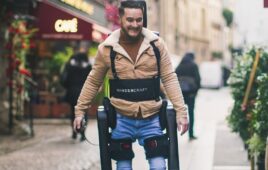 a person walking with help from Wandercraft's Personal Exoskeleton.