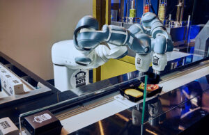 A dual-arm YuMi cobot puts the finishing touches on a BurgerBots meal.