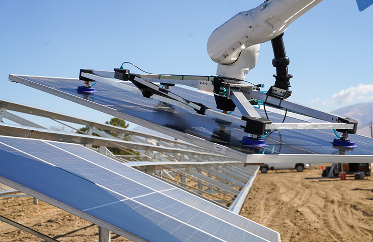 close up of the cosmic robot gripper, holding a single solar panel.
