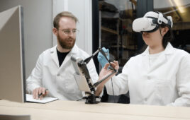 A person using the Haply Robotics Inverse3 device, which allows operators to directly manipulate robots while receiving real-time force feedback.