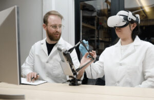 A person using the Haply Robotics Inverse3 device, which allows operators to directly manipulate robots while receiving real-time force feedback.