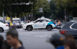 A Pony.ai vehicle driving on a busy street.