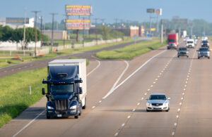 An Aurora ruck driving on a road in Texas.