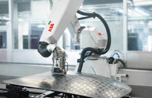 An ABB robot painting a car hood.