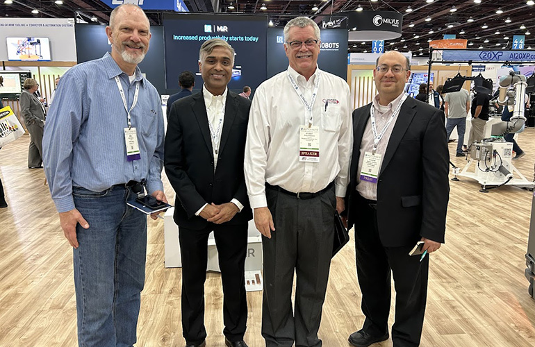 From left: Editor Mike Oitzman, Teradyne's Ujjwal Kumar, Engelberger Award honoree Stu Shepherd, and editor Eugene Demaitre at Universal Robots' exhibit in Detroit.