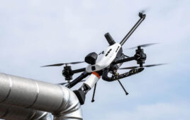 A Voliro drone inspecting a tube for corrosion under insulation.
