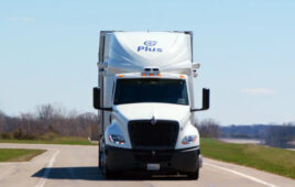 A Plus truck driving on a road.