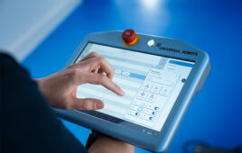 A person holding a Universal Robots tablet.