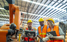 Factory workers look at a robot. J.P. Morgan has released a study about the financial state of applied technologies in U.S. industry.