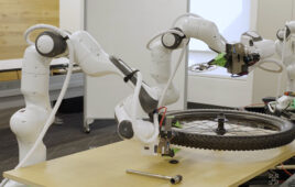 Two cobot arms putting a gear on a bike tire.