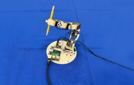 a robot arm holding a pencil at MIT.