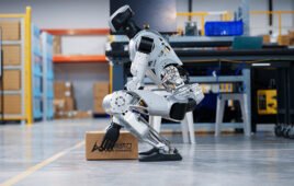 limx oli humanoid squats to pick up an item off the floor.