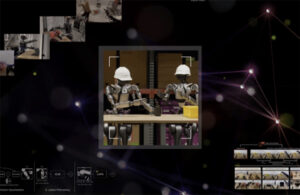 An image that features two humanoid robots learning to handle an object.