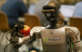 a humanoid robot holding an apple.